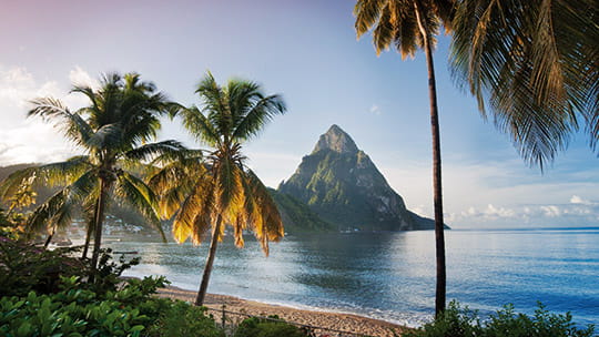 A view of a beach with the Pitons in the background, St Lucia